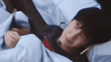 a blurry picture of a person laying in a bed with a phone