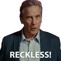 a man in a suit says " reckless " in front of his face