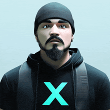 a man with a beard wearing a black hoodie with a blue x on it