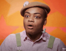 a man with a surprised look on his face wearing a beret and suspenders