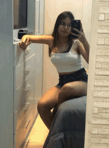 a girl taking a selfie in front of a mirror