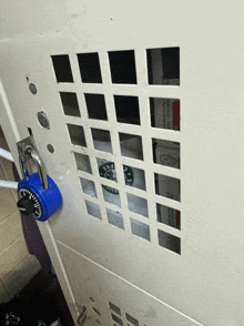 a blue padlock on a white locker with a starbucks coffee bag in it