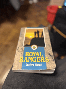 a book called royal rangers leaders manual is on a table