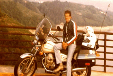 a man sits on a motorcycle with an elf helmet on the back