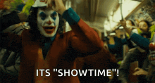 a man in a joker costume says " its showtime "
