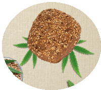 a piece of bread with sesame seeds on it is surrounded by marijuana leaves