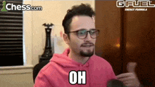 a man wearing glasses and a pink hoodie says oh on chess.com