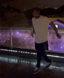 a man in a white shirt with the word guess on it is dancing