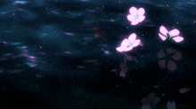 a few pink flowers are floating in the water at night