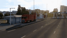 a red truck is driving down a highway near a building