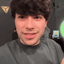 a close up of a man 's face with a triangle in the background and a sticker that says ' a '