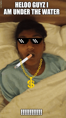 a boy wearing sunglasses and a dollar sign necklace laying in bed