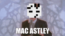 a man in a suit is singing into a microphone with the name mac astley above him