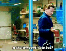 a man standing in front of a window with the words is this windows vista bad written on it