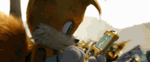 tails from sonic the hedgehog is holding a yellow device in his hand