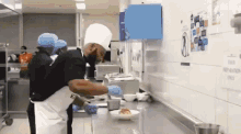 a man in a chef 's hat is preparing food in a kitchen with a sign on the wall that says preparation only