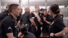 a group of police officers are standing around a table with abc written on the bottom