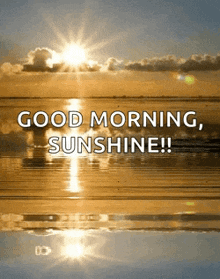 a good morning sunshine greeting card with the sun shining over the ocean .