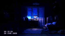 a dark room with a computer on a desk and a blue light coming out of the window .