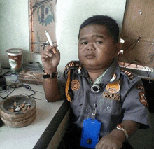 a police officer is smoking a cigarette in front of an ashtray