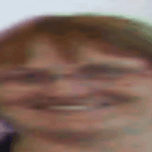 a blurry picture of a man 's face with glasses on