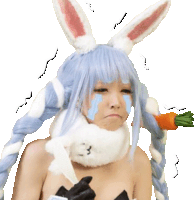 a woman in a bunny costume is crying while holding a carrot in her hand