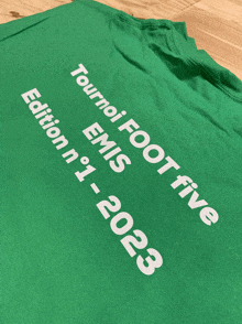 a green t-shirt that says tournei foot five emis edition n ° 1 - 2023