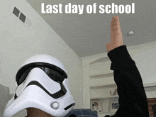 a person wearing a storm trooper helmet with the words last day of school above