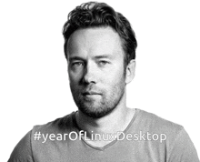 a black and white photo of a man with the hashtag #yearoflinuxdesktop