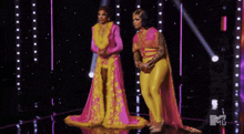 a blurry picture of a woman in a pink and yellow dress with a mtv logo in the corner