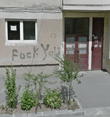 a building with the word fuck you written on the side