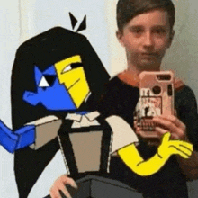 a boy is taking a selfie with a cartoon character while holding a cell phone .