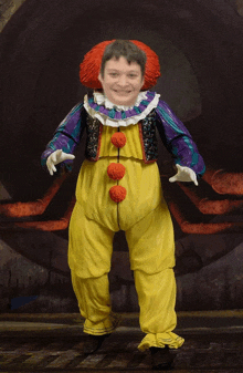 a boy in a clown costume with a red hat