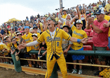 a man wearing a yellow jersey that says boston on it