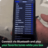 a person holding a phone that says connect via bluetooth and play your favorite tunes while you box on the bottom