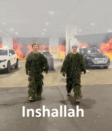 two men in sniper suits are walking in a parking lot with the word inshallah above them