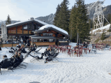 a snowy area with tables and chairs in front of a building that says la sente