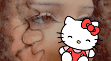 a close up of a woman 's face with a hello kitty in front of it