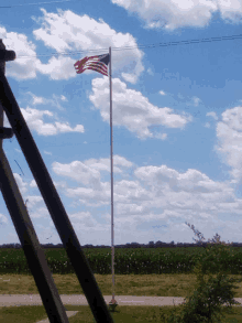 an american flag on a pole in a field