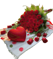 a bouquet of red roses and a red heart on a white blanket