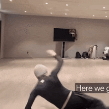 a person is laying on the floor in a room with the words here we go on the bottom