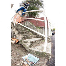 a skateboarder is doing a trick on a railing over a set of stairs