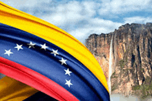 a venezuelan flag is waving in front of a mountain