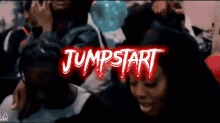 a group of people are gathered in a room with the words jumpstart in red letters