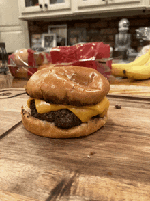 a cheeseburger is on a wooden cutting board