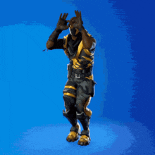 a man in a black and yellow costume is dancing on a blue background .