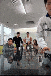 a group of people sitting around a table with a man wearing a jersey that says ' eysb ' on it