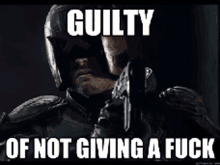 a man in a helmet is holding a gun with the words guilty of not giving a fuck .