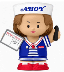 a figurine of ahoy from stranger things holding a cell phone and a sign