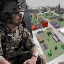 a soldier wearing a helmet and goggles is smiling while looking at a map of a city